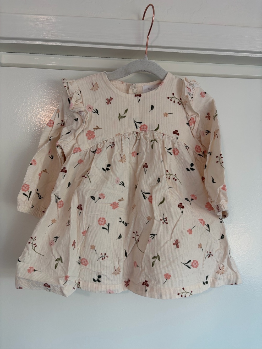 Angel Deer “Floating Floral Shoulder Ruffle Dress” in Cream.